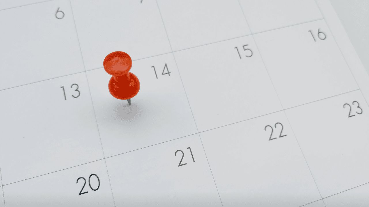 Some Dates Never Get Easier A close-up of a white monthly calendar with a red pushpin marking a specific day, symbolizing a significant anniversary or a date etched in memory for New Brunswick policing.